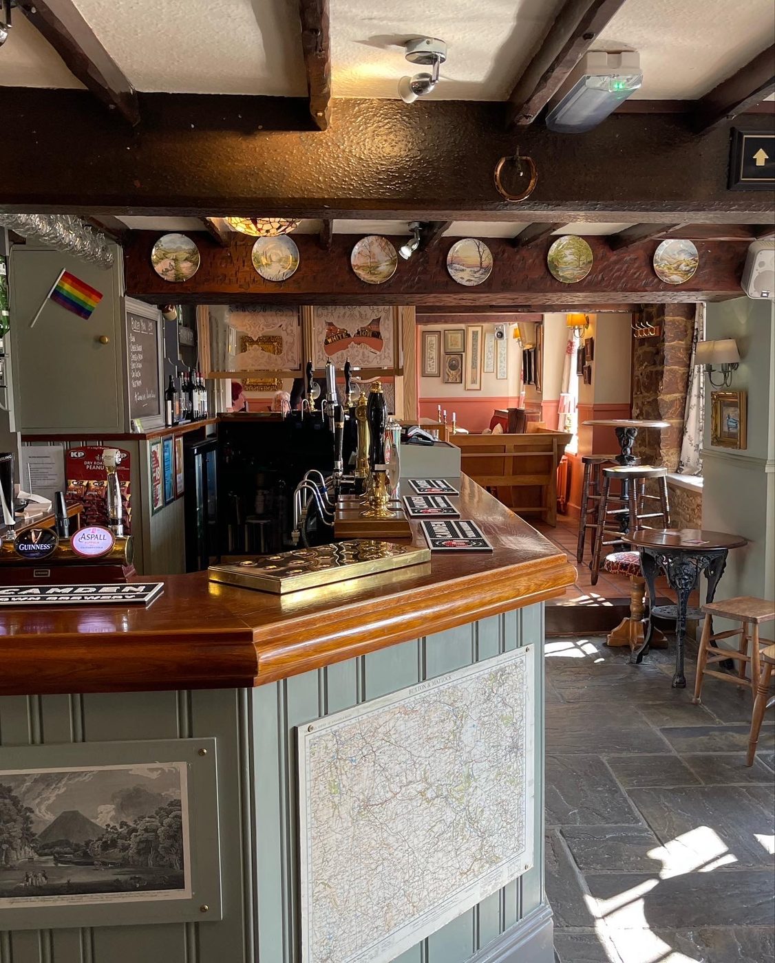 The bar counter, with plates on the wall