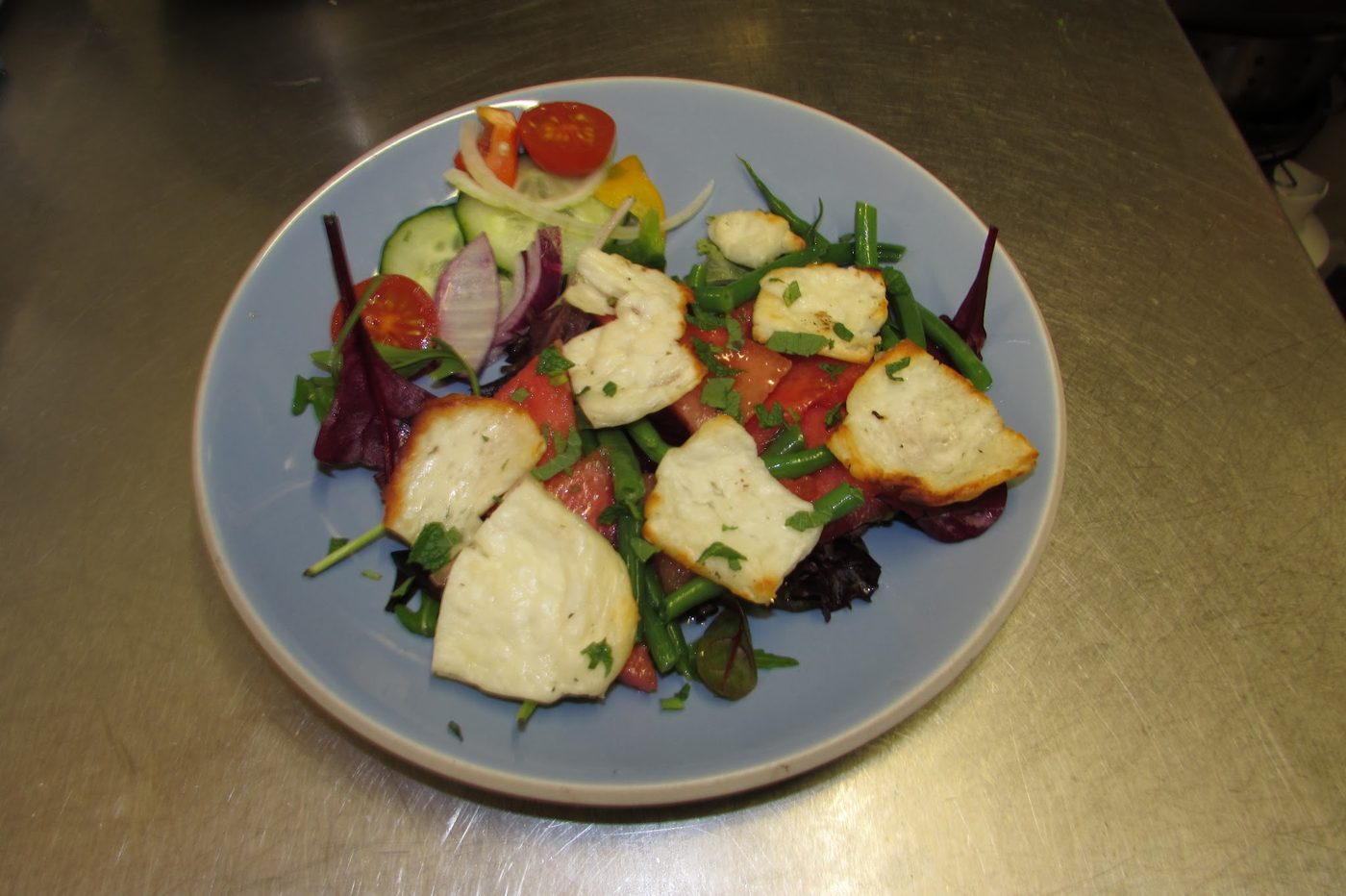 A salad on a blue plate